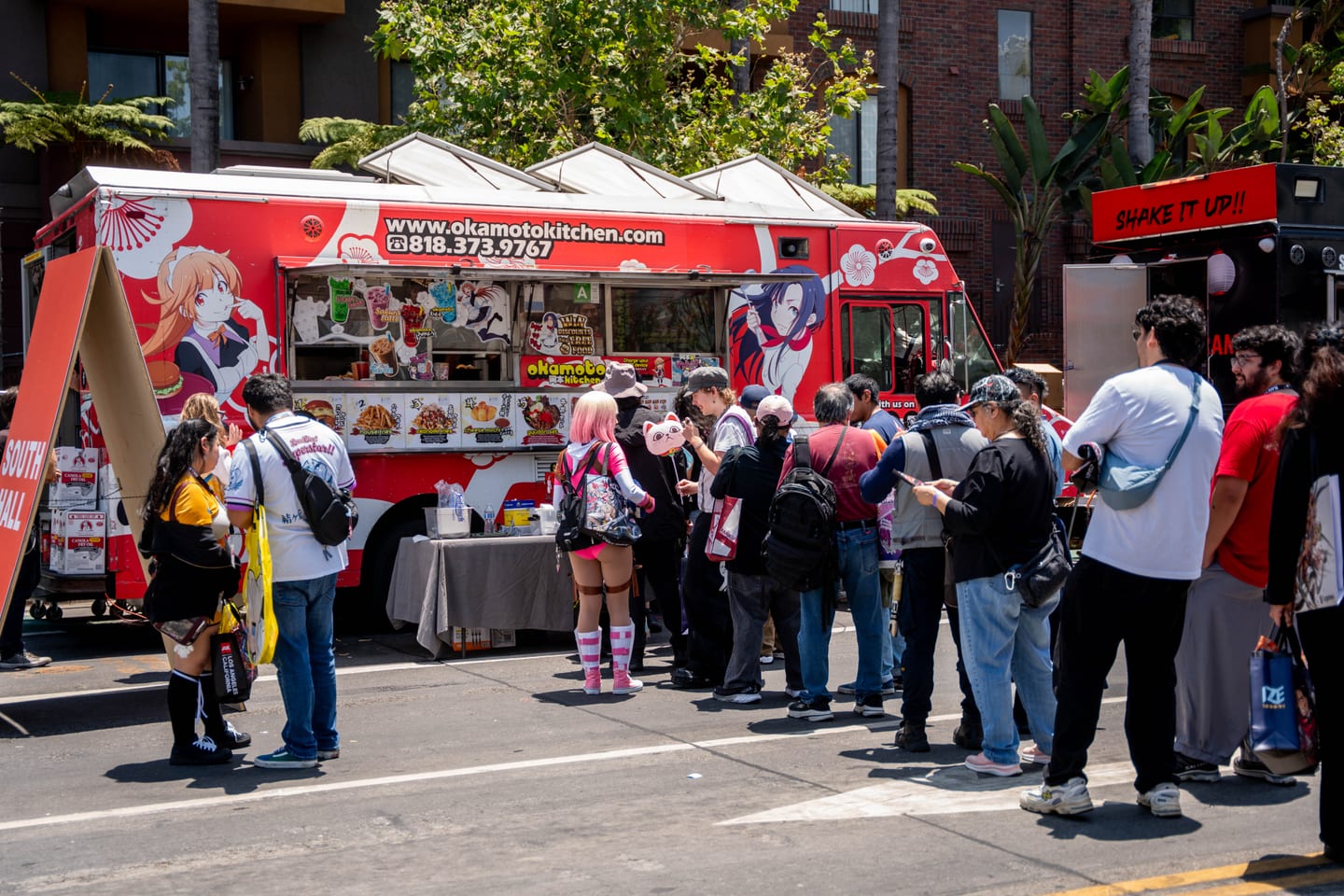 A crowd lined up at the Okamoto’s Kitchen food truck among the food-truck row outside Anime Expo 2026