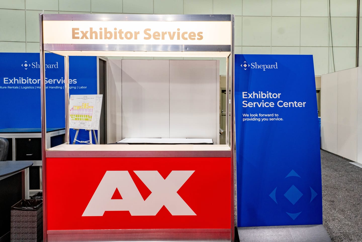 The Shepard Exhibitor Services center booth with Anime Expo AX branding on the convention show floor