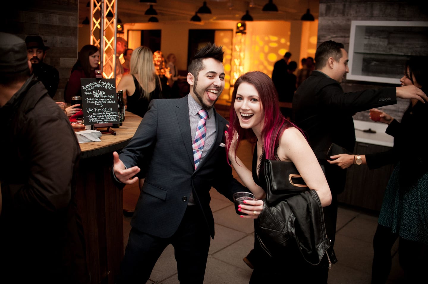 Group of guests having fun at the bar during a private party