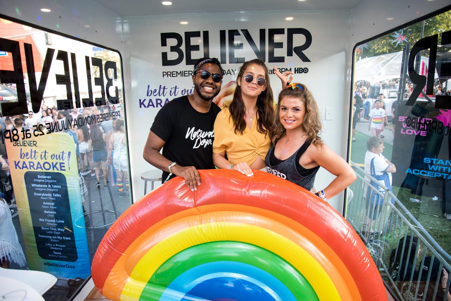 Guests with a rainbow float at HBO’s LGBTQ+ “Believer” pop-up in Los Angeles