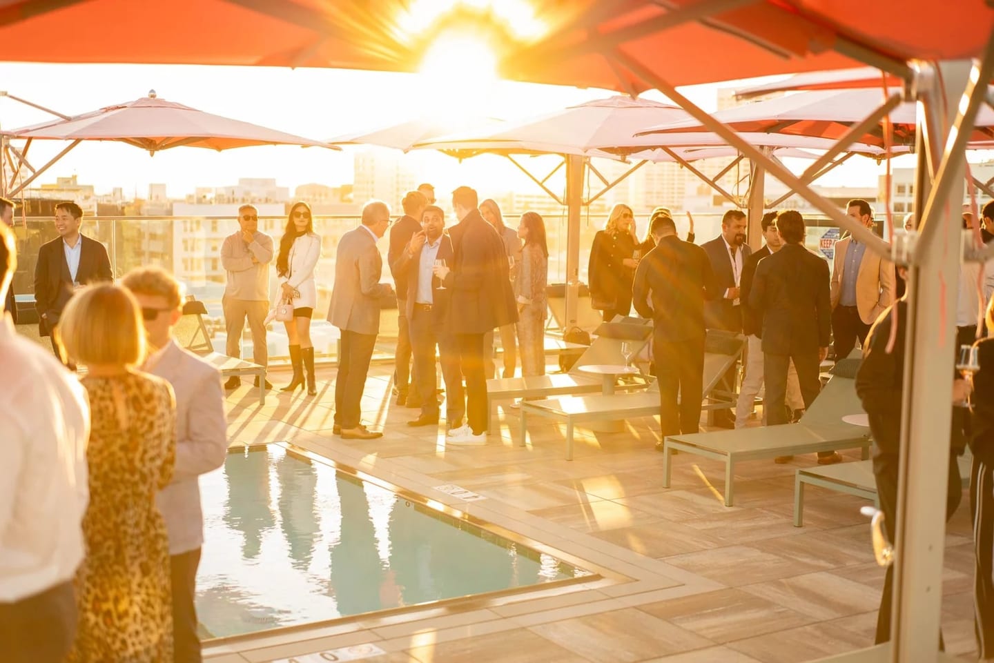 Guests at a golden-hour rooftop reception for the 700 Broadway grand opening in Santa Monica