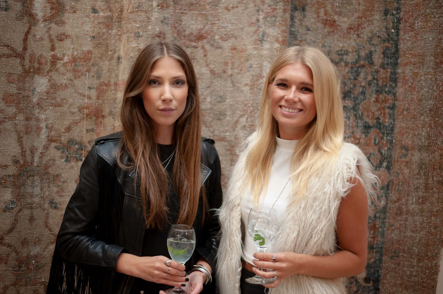 Two guests with cocktails at an upscale party