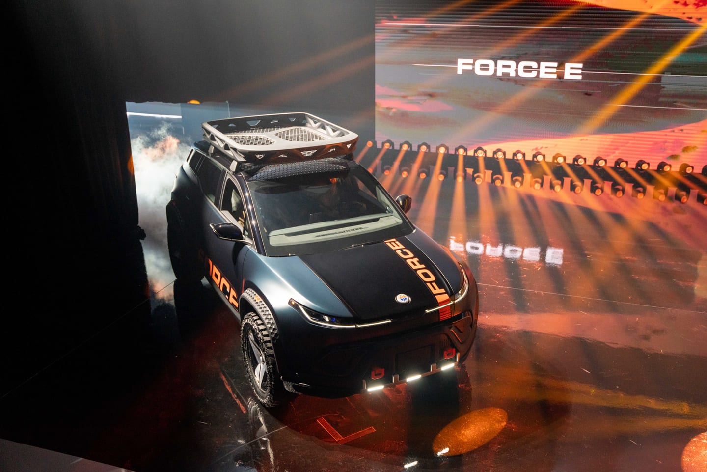 Overhead view of the Fisker Ocean Force E and its roof rack beneath the FORCE E screen