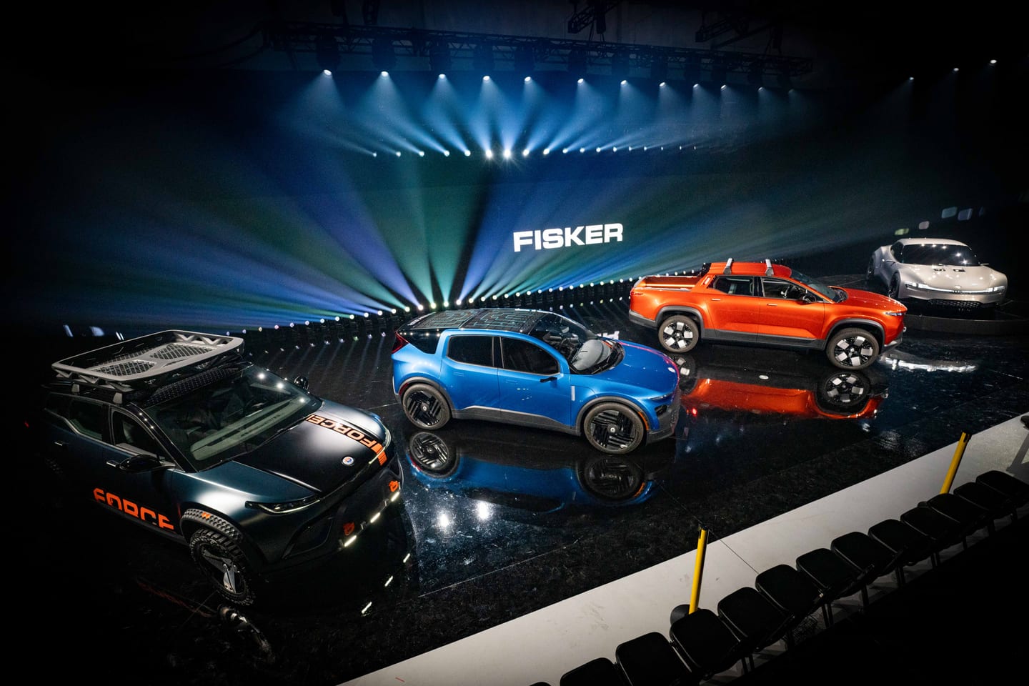 Overhead view of the Fisker lineup — the Force E, PEAR, Alaska and Ronin staged beneath the FISKER screen