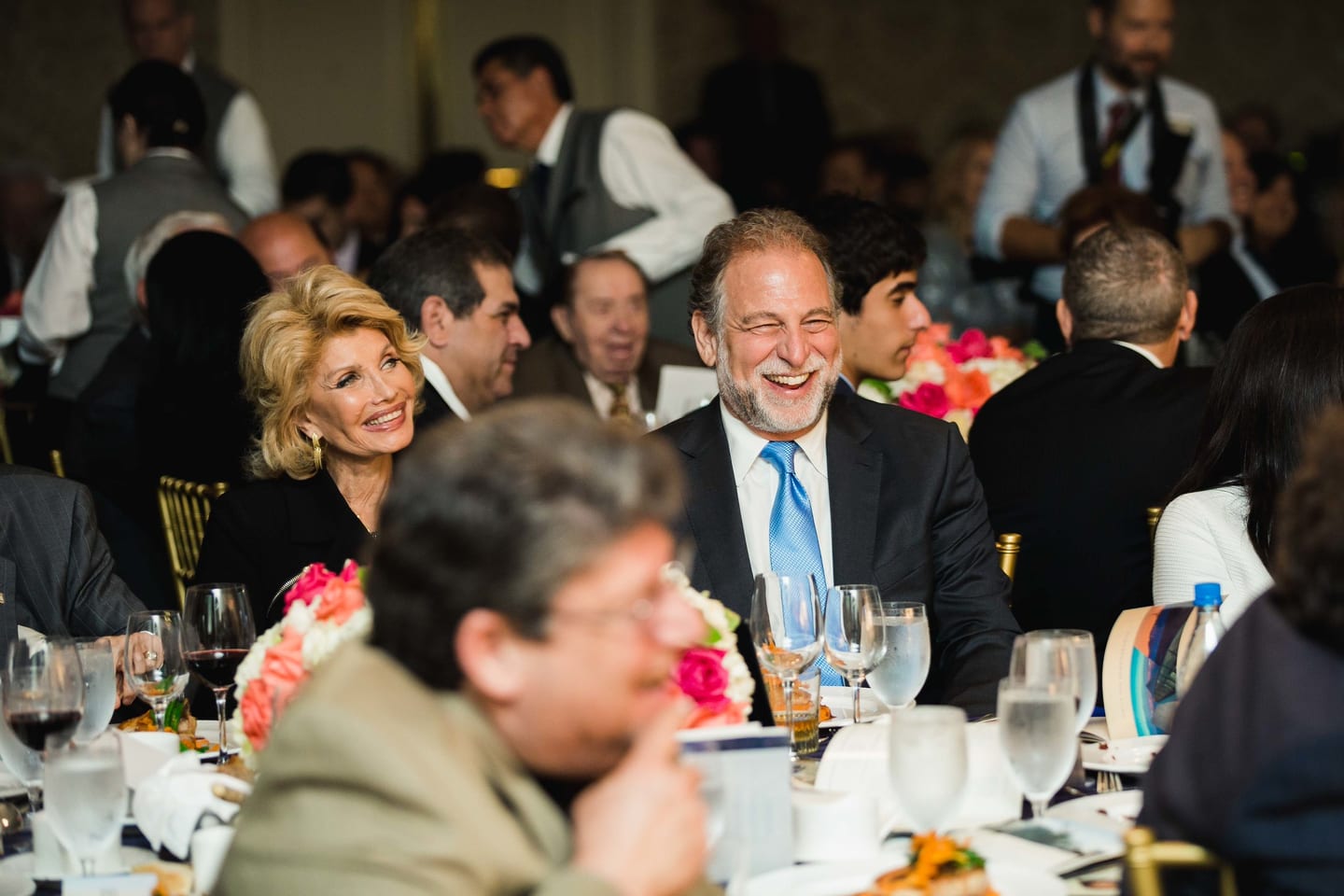 Guest laughing at a gala luncheon table