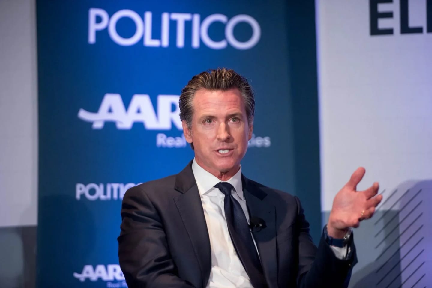 Gov. Gavin Newsom speaking at a political summit, photographed for Politico