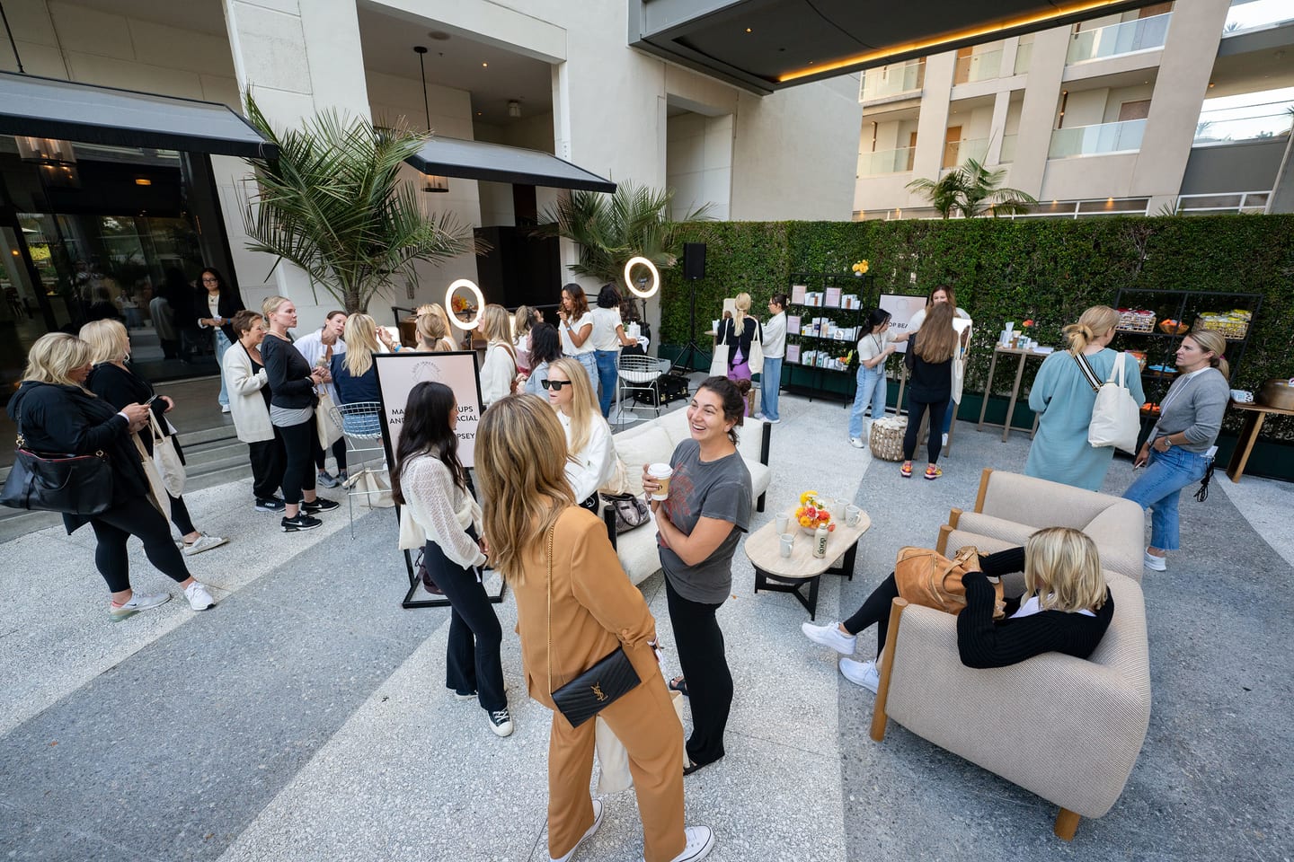 Guests mingling among product displays and ring lights at an outdoor goop wellness activation