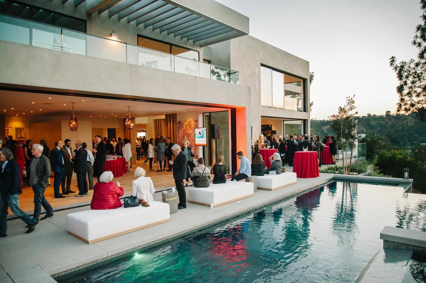 Guests at a private sunset reception around the pool of a modern Hollywood Hills estate