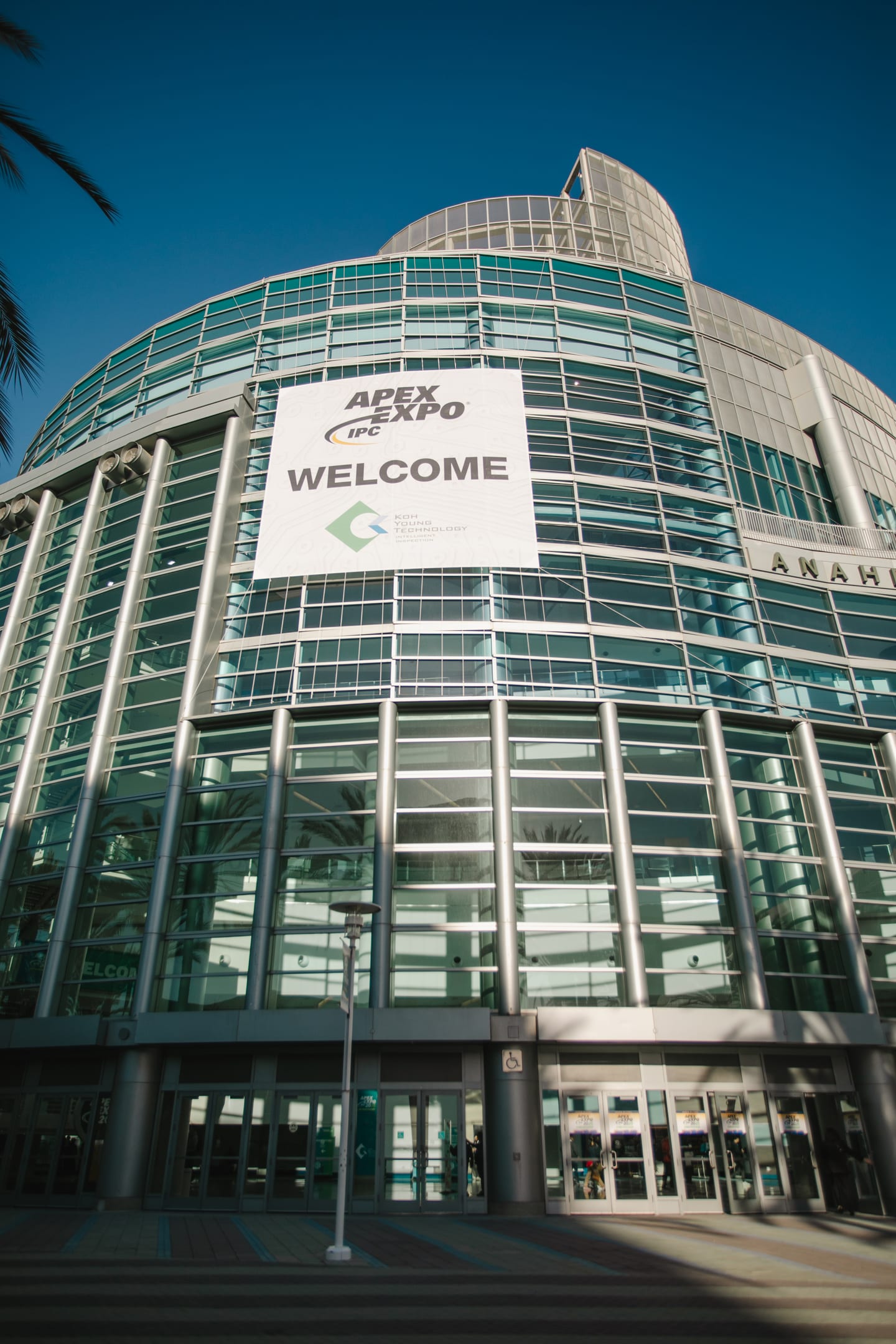 Exterior of the Anaheim Convention Center with a large IPC APEX EXPO welcome banner