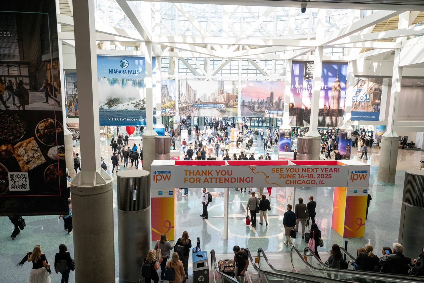 The Los Angeles Convention Center lobby filled with IPW delegates beneath a Thank You For Attending screen and escalators