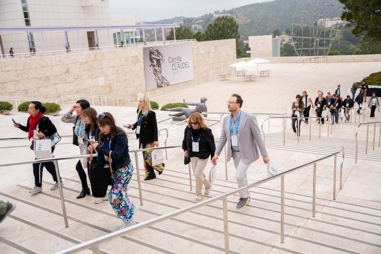 IPW delegates gathered on the travertine steps of the Getty Center at an offsite press event above Los Angeles