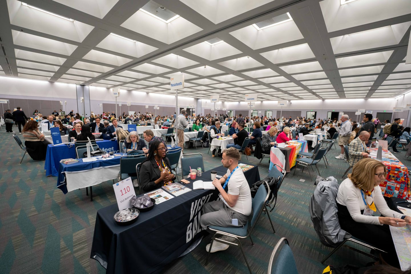 A wide view of the IPW Media Marketplace hall filled with rows of appointment tables and meeting delegates