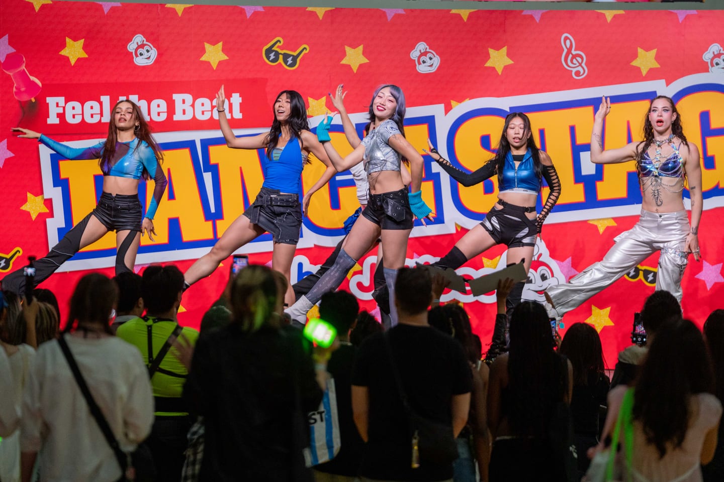 Five performers mid-routine on the “Feel the Beat” dance stage as a crowd watches at KCON, Los Angeles Convention Center