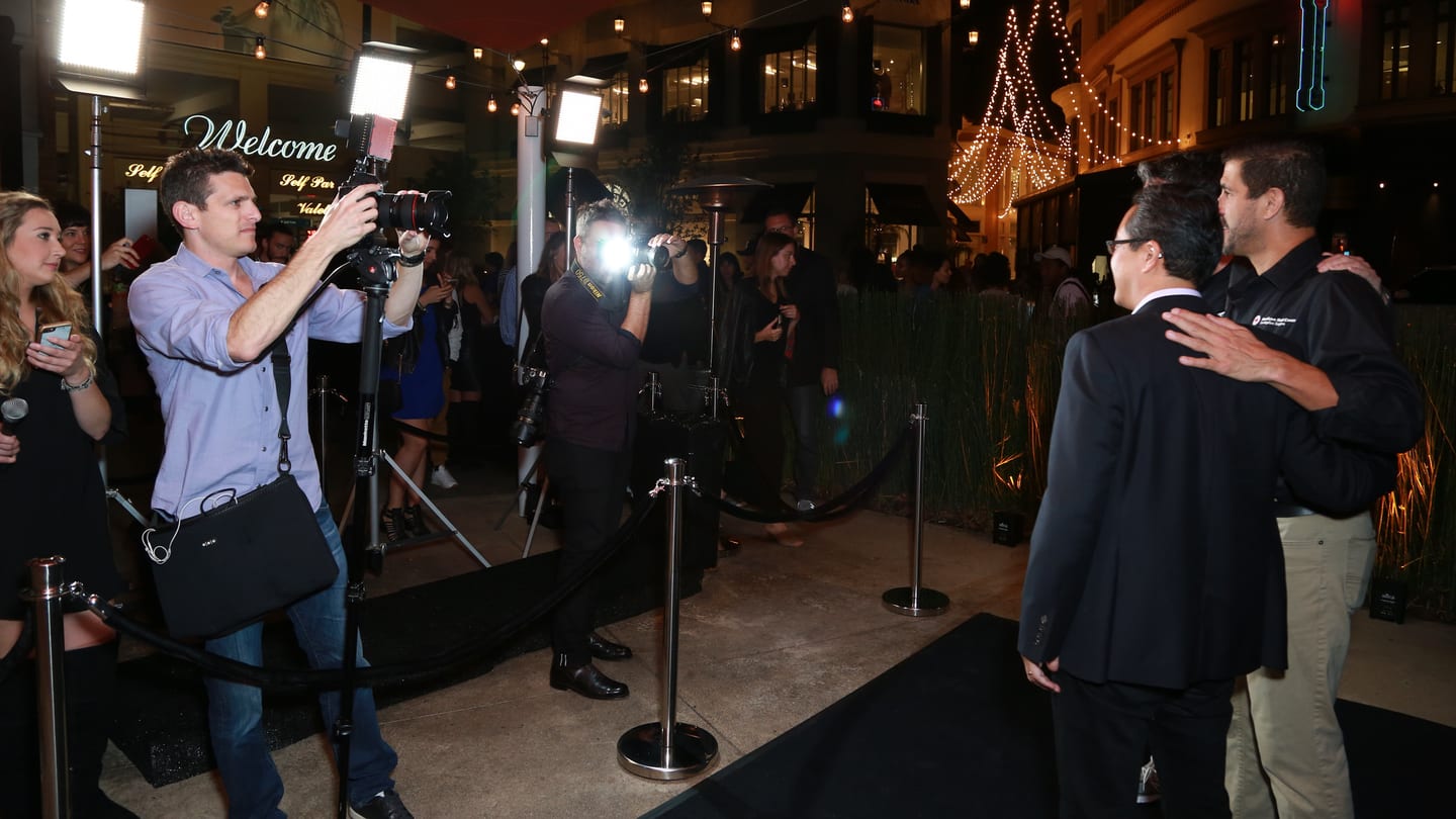 Los Angeles event photographer Kyle Espeleta shooting a red carpet arrival at night