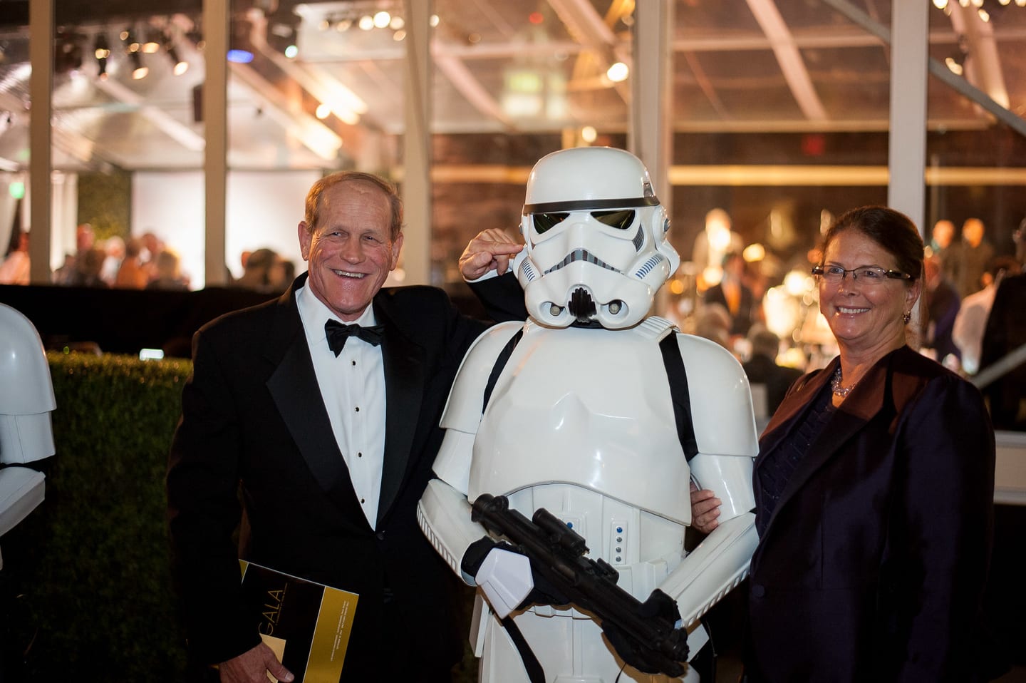 Guest in black tie posing with a Stormtrooper at an LA Philharmonic gala