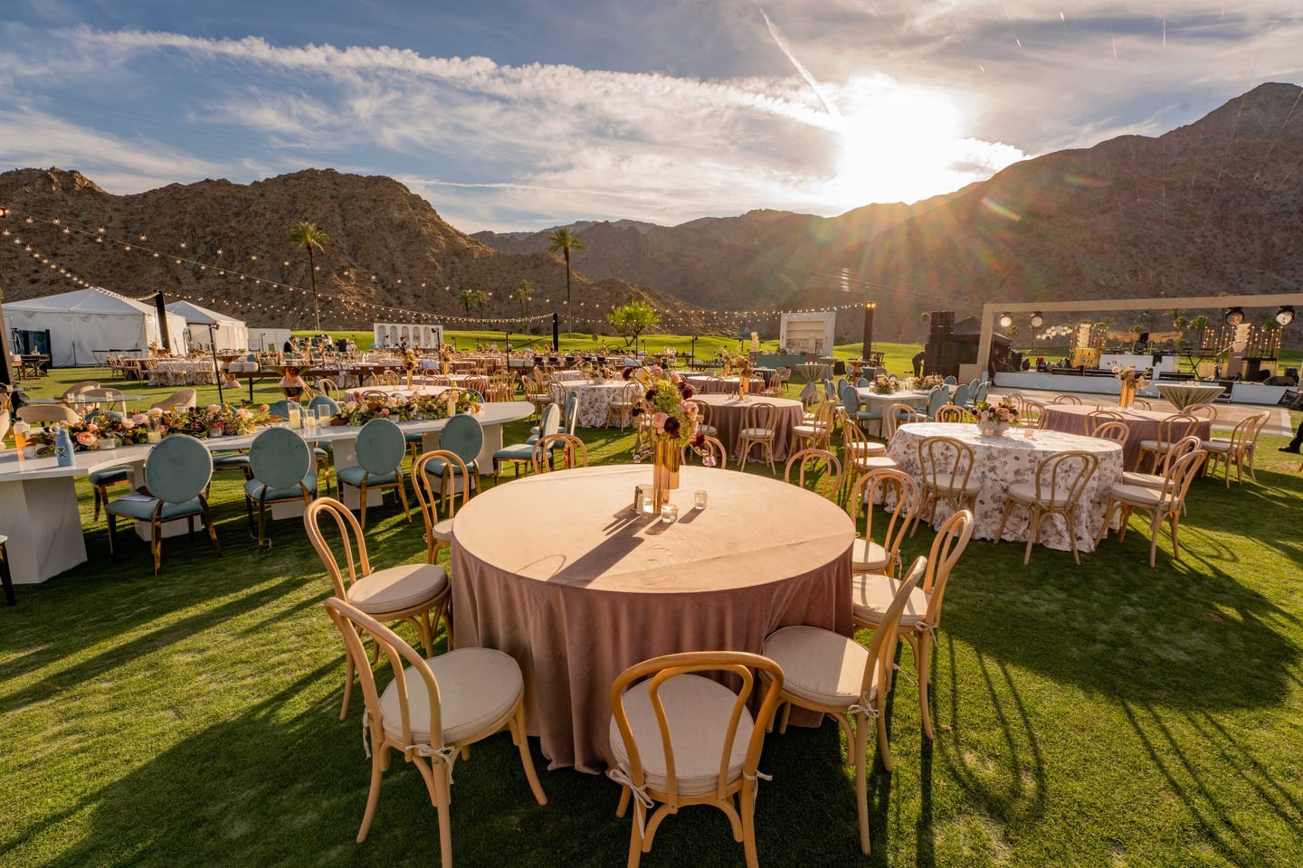 Outdoor event setup at golden hour against the desert mountains in La Quinta