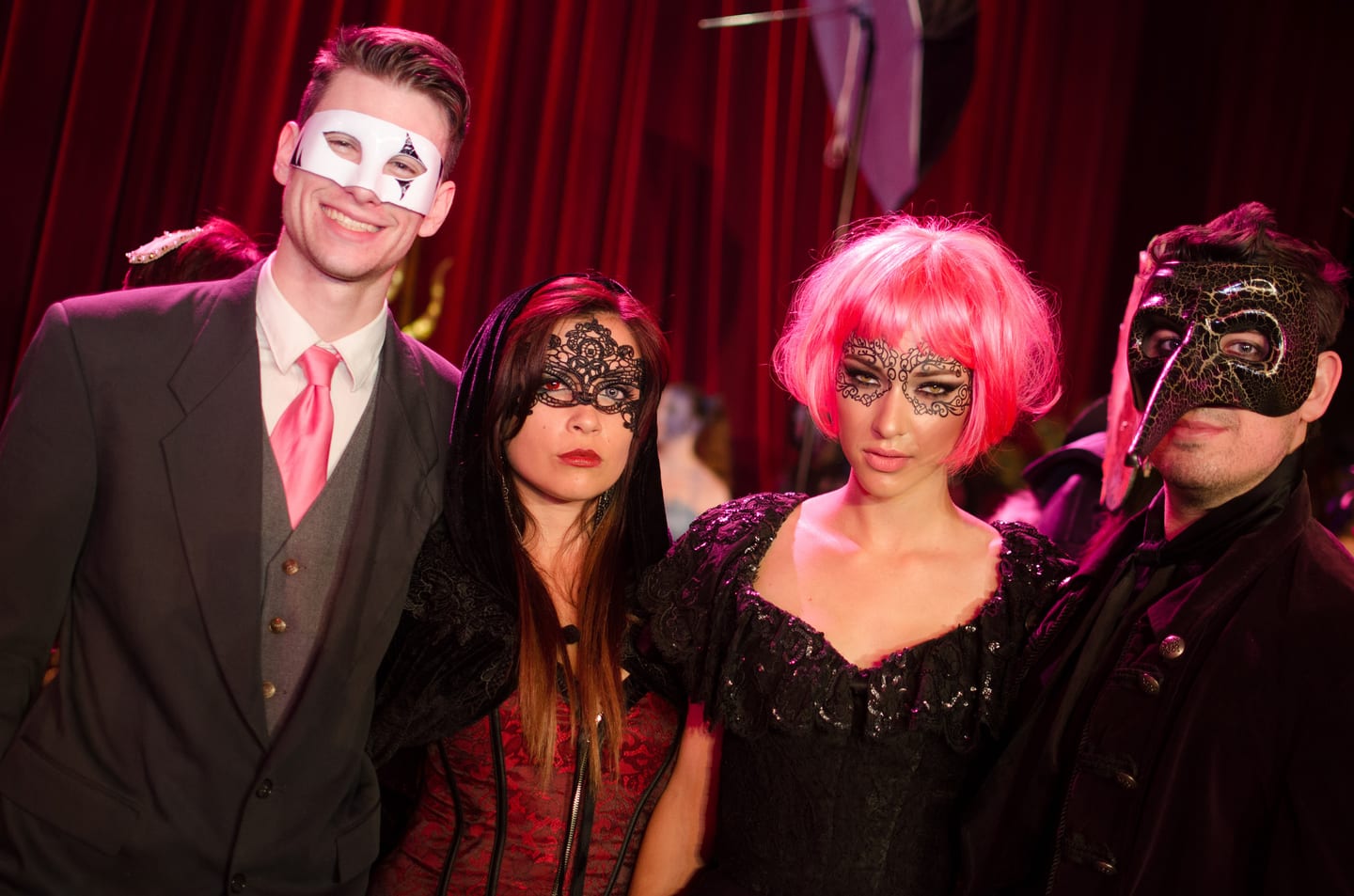 Guests in masks and costumes at a masquerade party