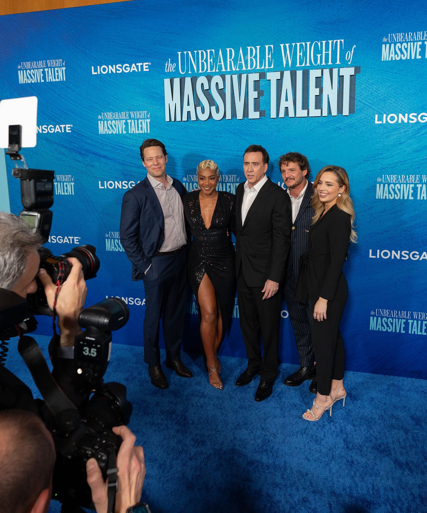 Cast of The Unbearable Weight of Massive Talent — Nicolas Cage, Pedro Pascal, Tiffany Haddish, and Ike Barinholtz — on the blue carpet at the Lionsgate premiere