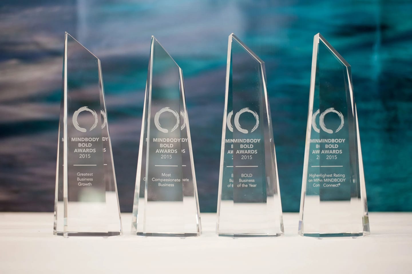 A row of glass award trophies for the Mindbody BOLD Awards