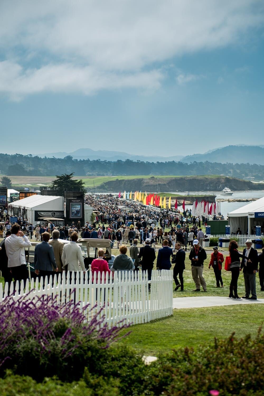 Crowd among classic cars at a Monterey car event
