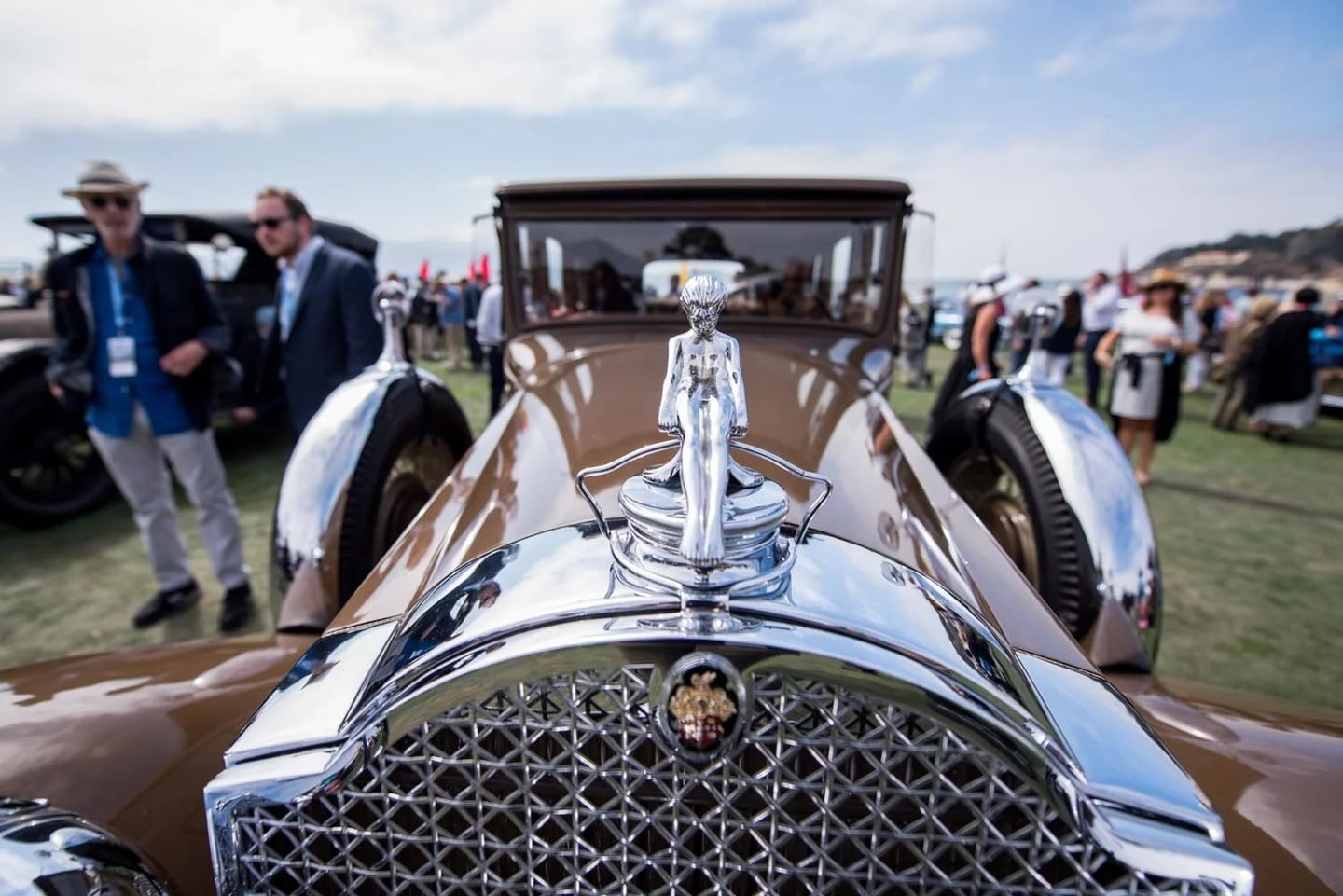 Chrome hood ornament and grille detail on a vintage automobile displayed during Monterey Car Week