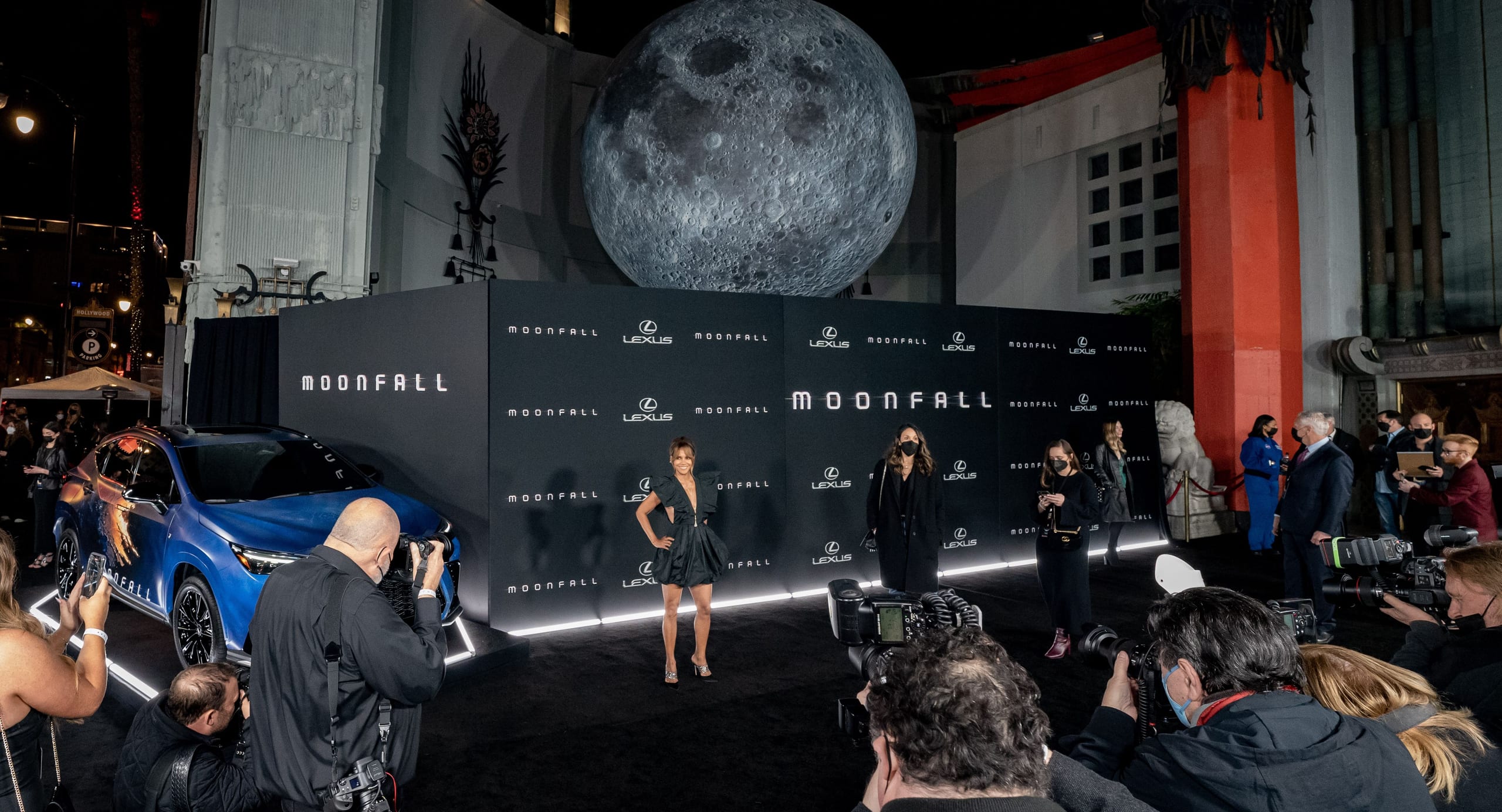 Halle Berry on the carpet at the Moonfall premiere backdrop, with a giant moon sphere and a Lexus display, outside the TCL Chinese Theatre in Hollywood
