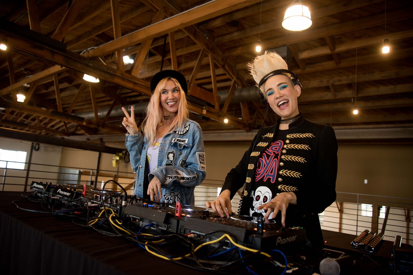 NERVO smiling behind a Pioneer DJ setup during a Virgin and Stoli event in Los Angeles