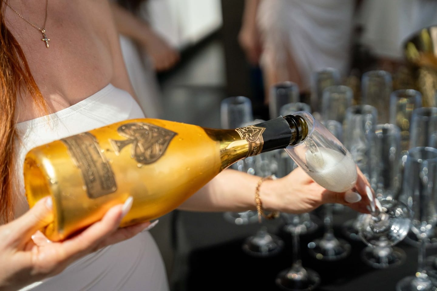 Gold Armand de Brignac Ace of Spades champagne poured into a glass at a private Hollywood Hills party