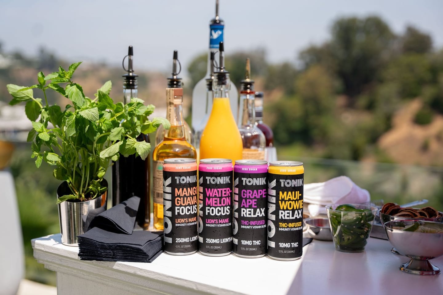 Hemp-derived THC beverage cans displayed on the bar at a private Hollywood Hills party