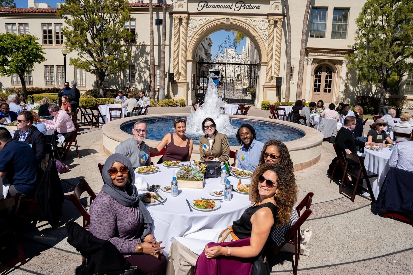 Guests at lunch tables beside the fountain on the Paramount Pictures studio lot