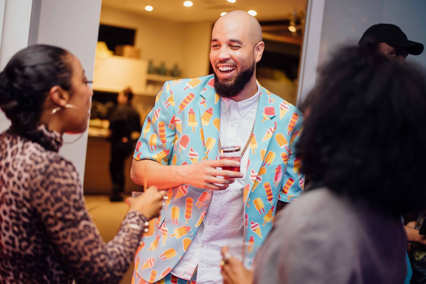 Guest in a printed shirt laughing at a party