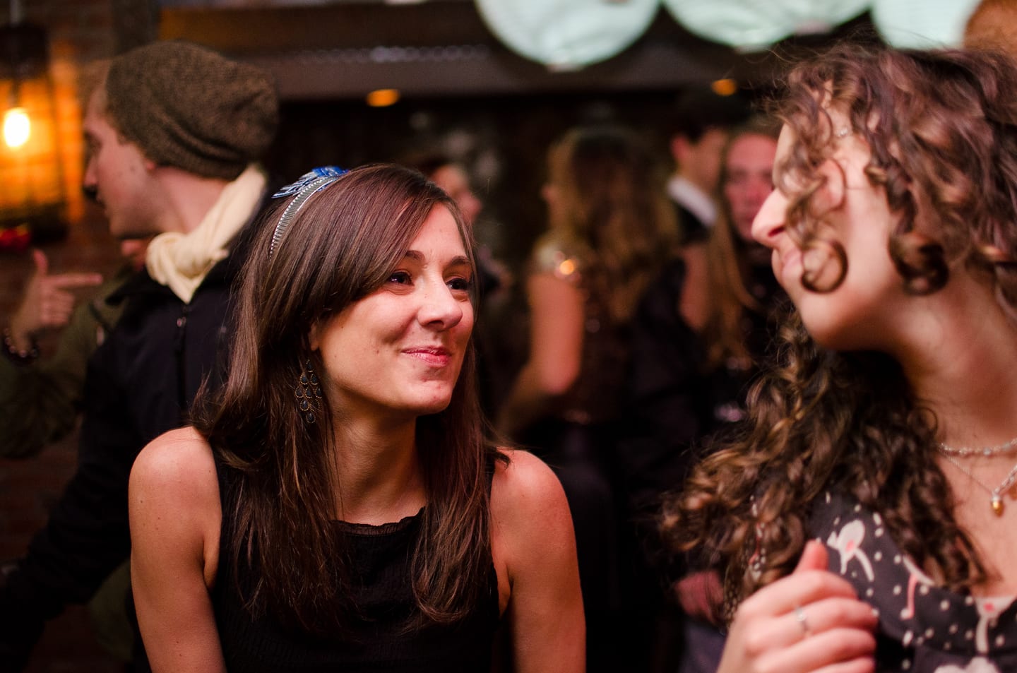 Candid profile of a guest smiling at a party