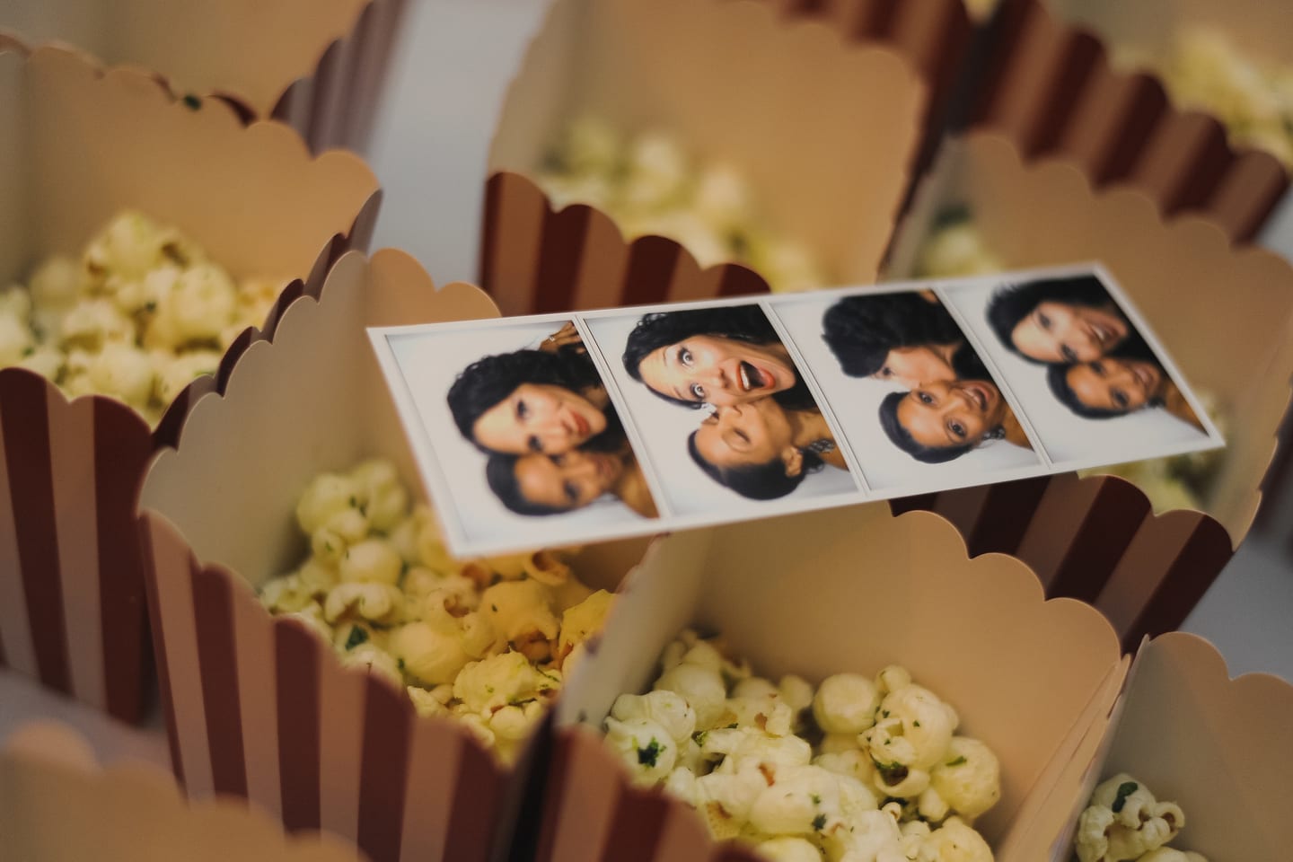 Popcorn boxes and photo-booth strips at a birthday party