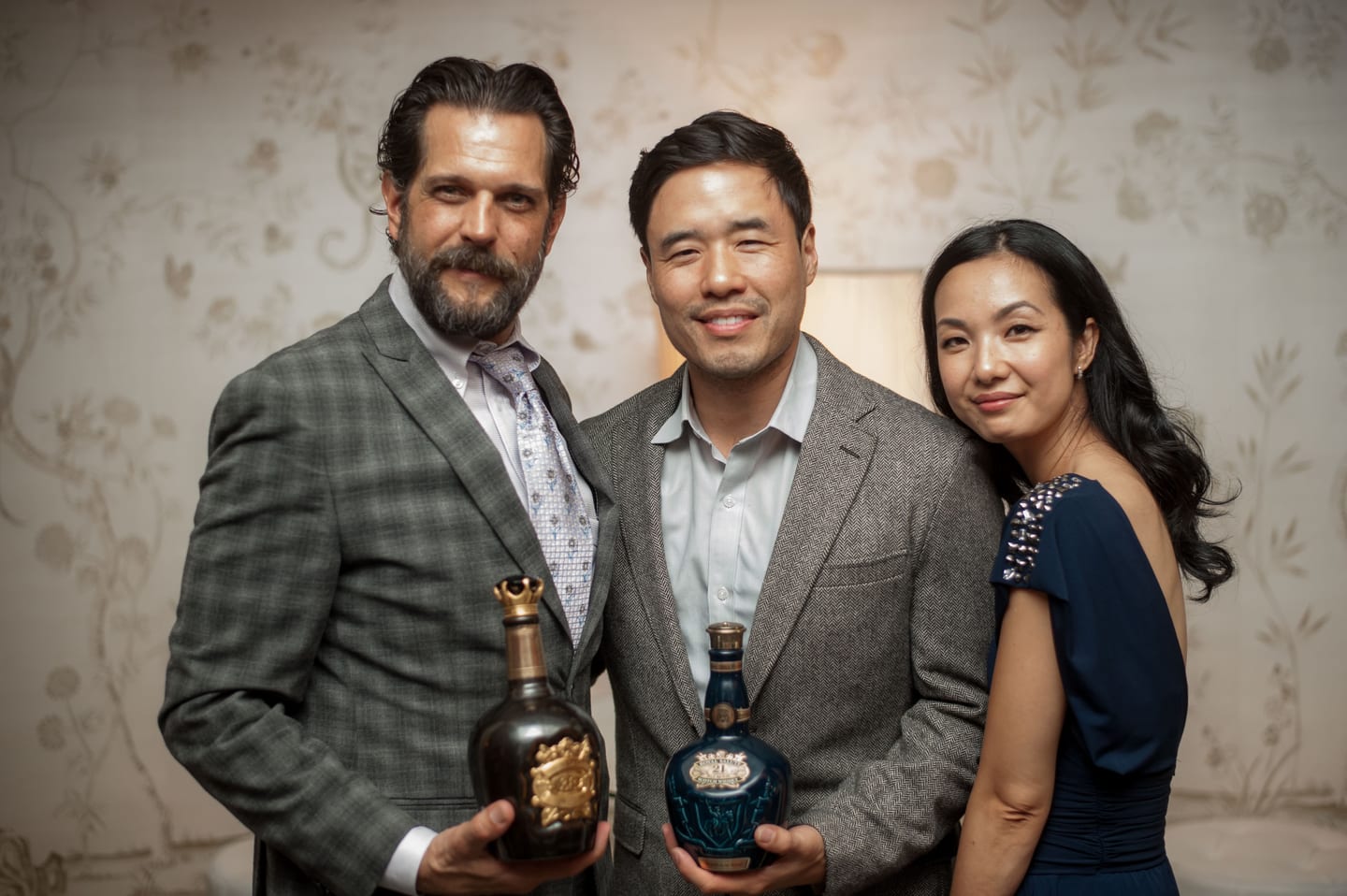 Randall Park holding a Royal Salute decanter with fellow guests at the Unforgettable Gala selection dinner, photographed for Character Media