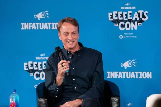 Tony Hawk speaking with a microphone at EEEEEATSCON, photographed for ET Online