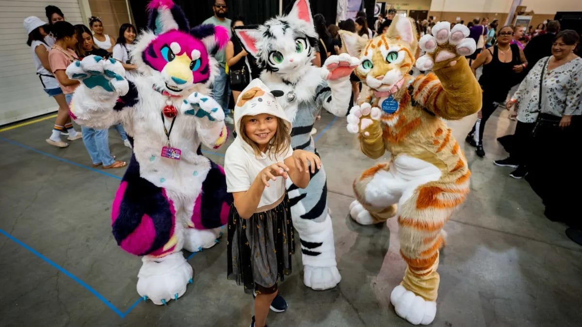 A child with costumed performers at CatCon, photographed for NBC Los Angeles