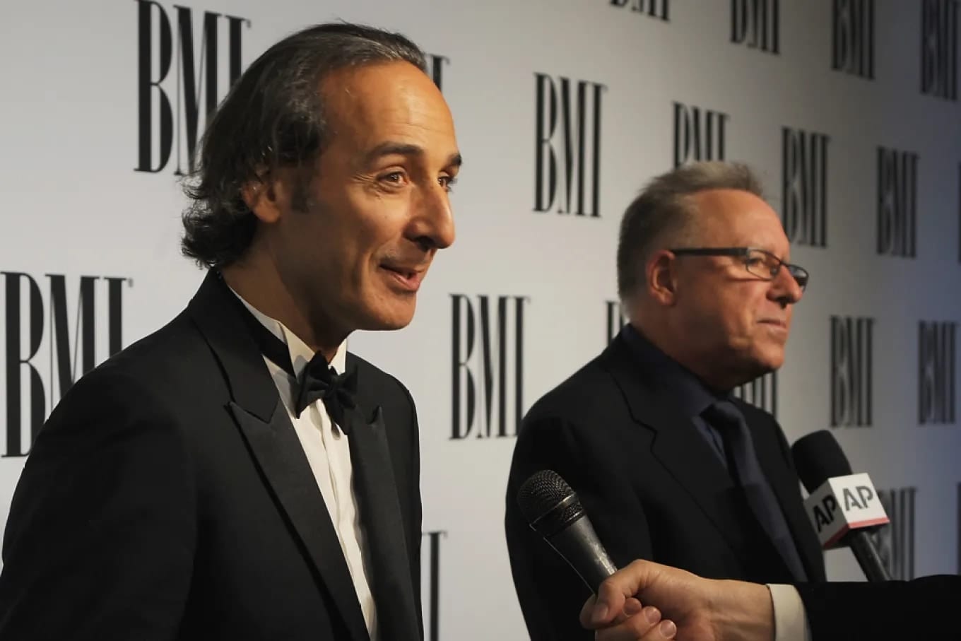 Alexandre Desplat interviewed beside Chris Montan at the BMI Film and TV Awards step-and-repeat, photographed for Variety