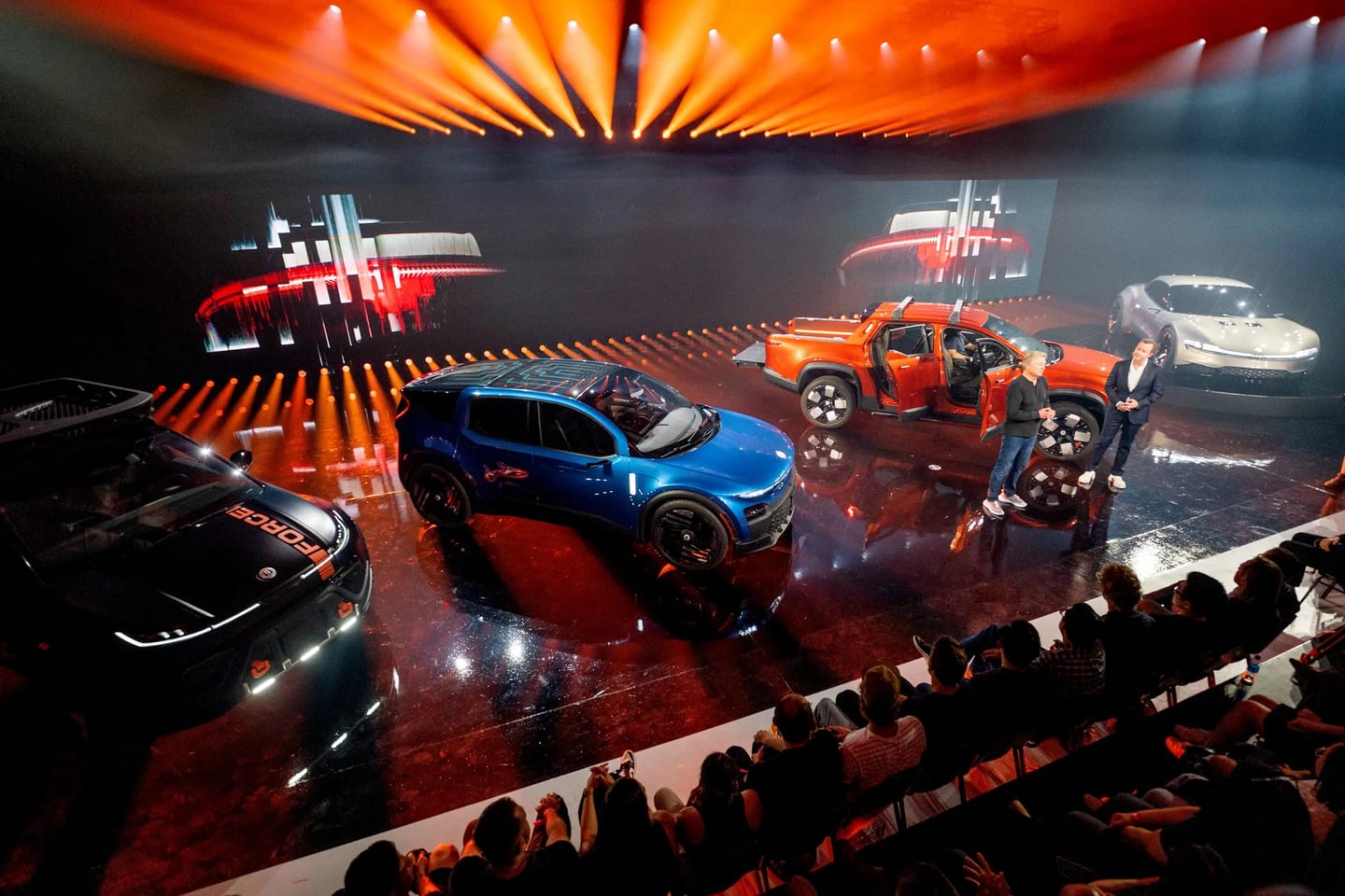 Fisker electric vehicles on a lit reveal stage, photographed for coverage published in WIRED