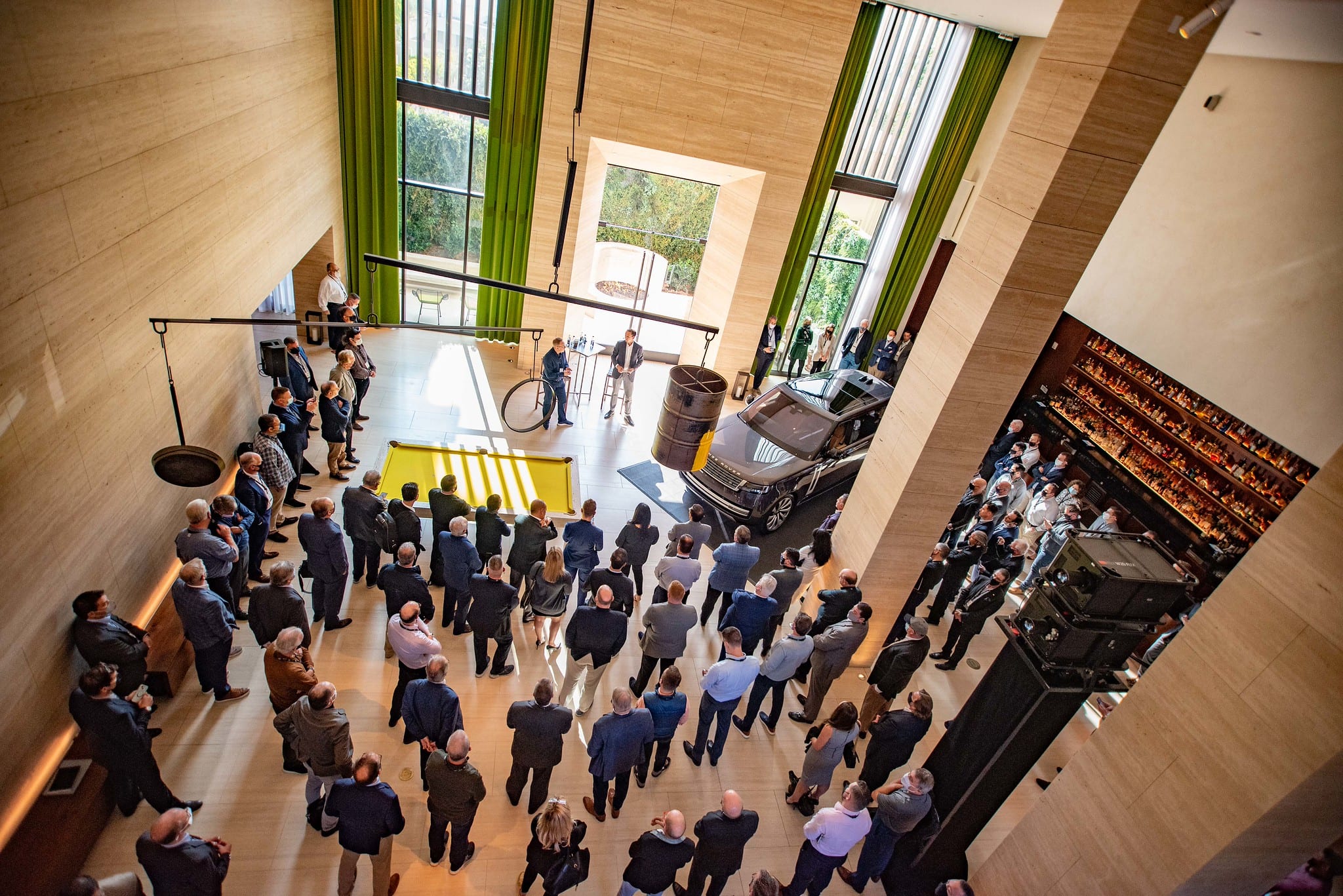 Guests gathered around the new Range Rover at a launch event, shot from above