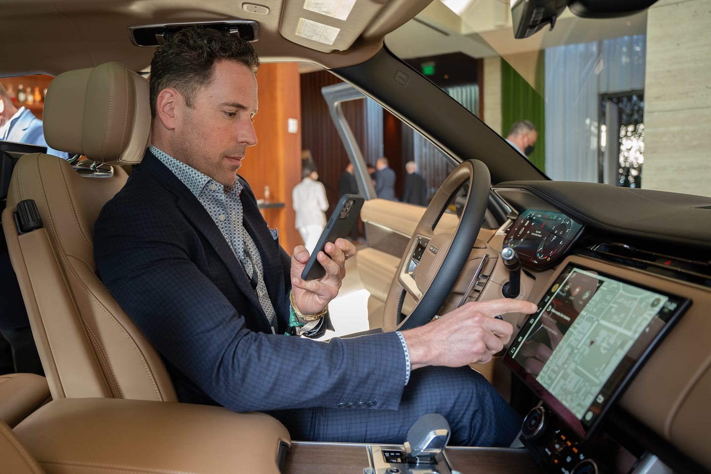A guest in the driver’s seat exploring the Range Rover infotainment display at a Range Rover event in Hollywood