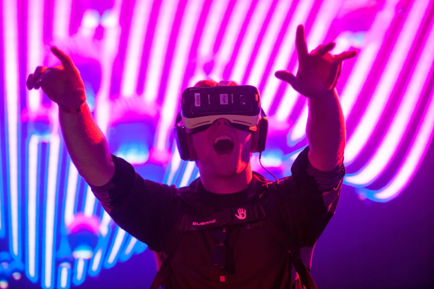 Attendee reacting inside a Samsung VR headset against a neon-lit activation backdrop