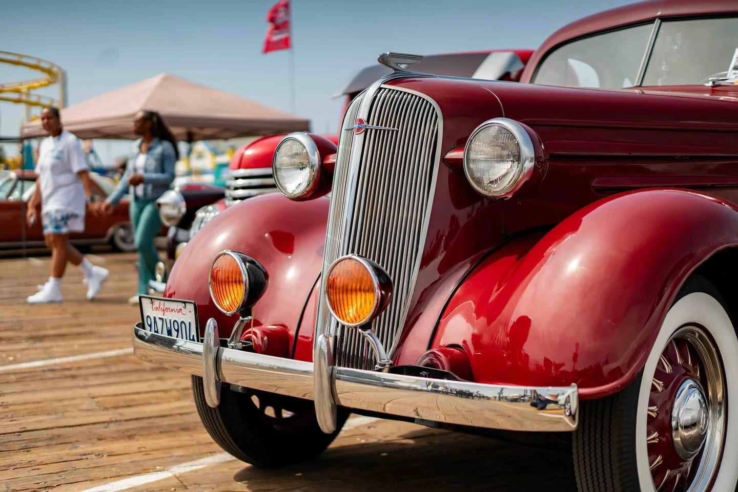 A polished red vintage car on display at the Santa Monica Classic Car Show on the Pier