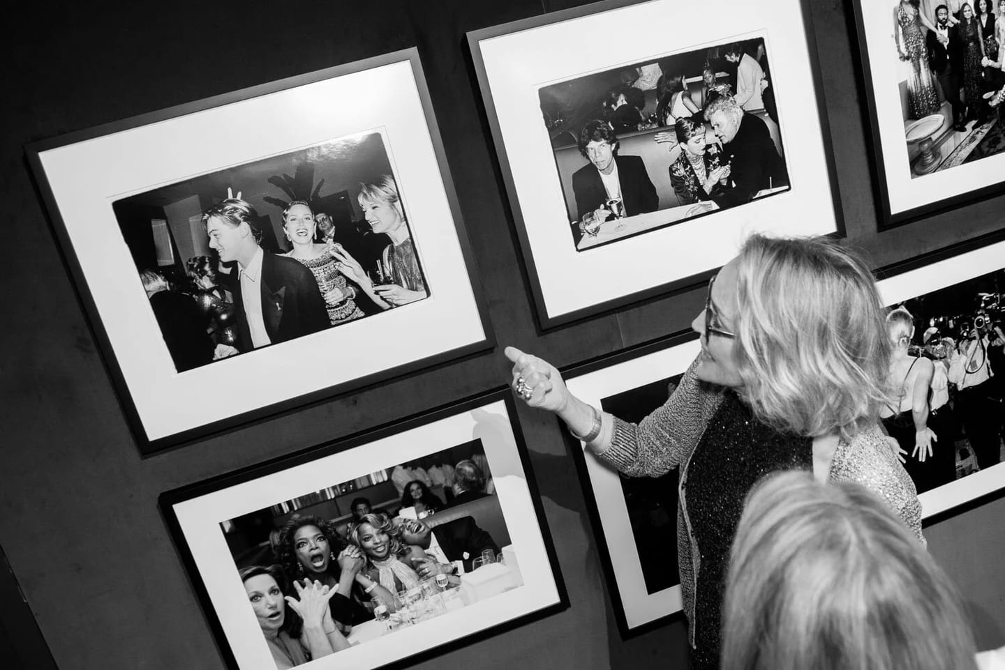 Sharon Stone pointing to a framed Vanity Fair photograph of Leonardo DiCaprio at the Hollywood Calling exhibition opening at the Annenberg Space for Photography