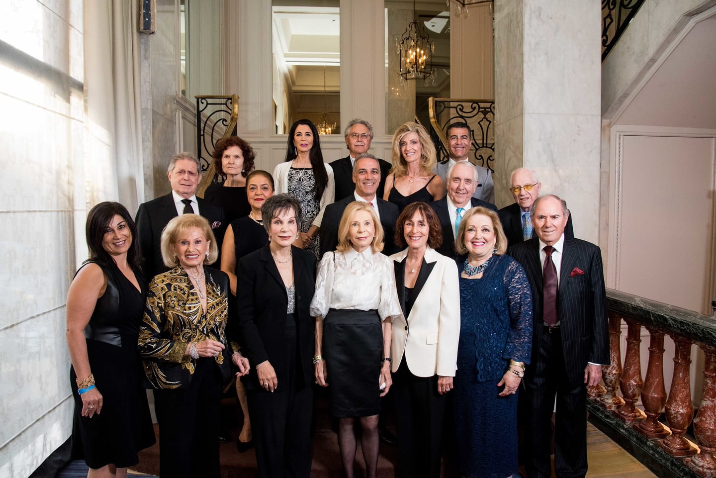 Formal group portrait on a grand staircase at the Friends of Sheba gala in Beverly Hills