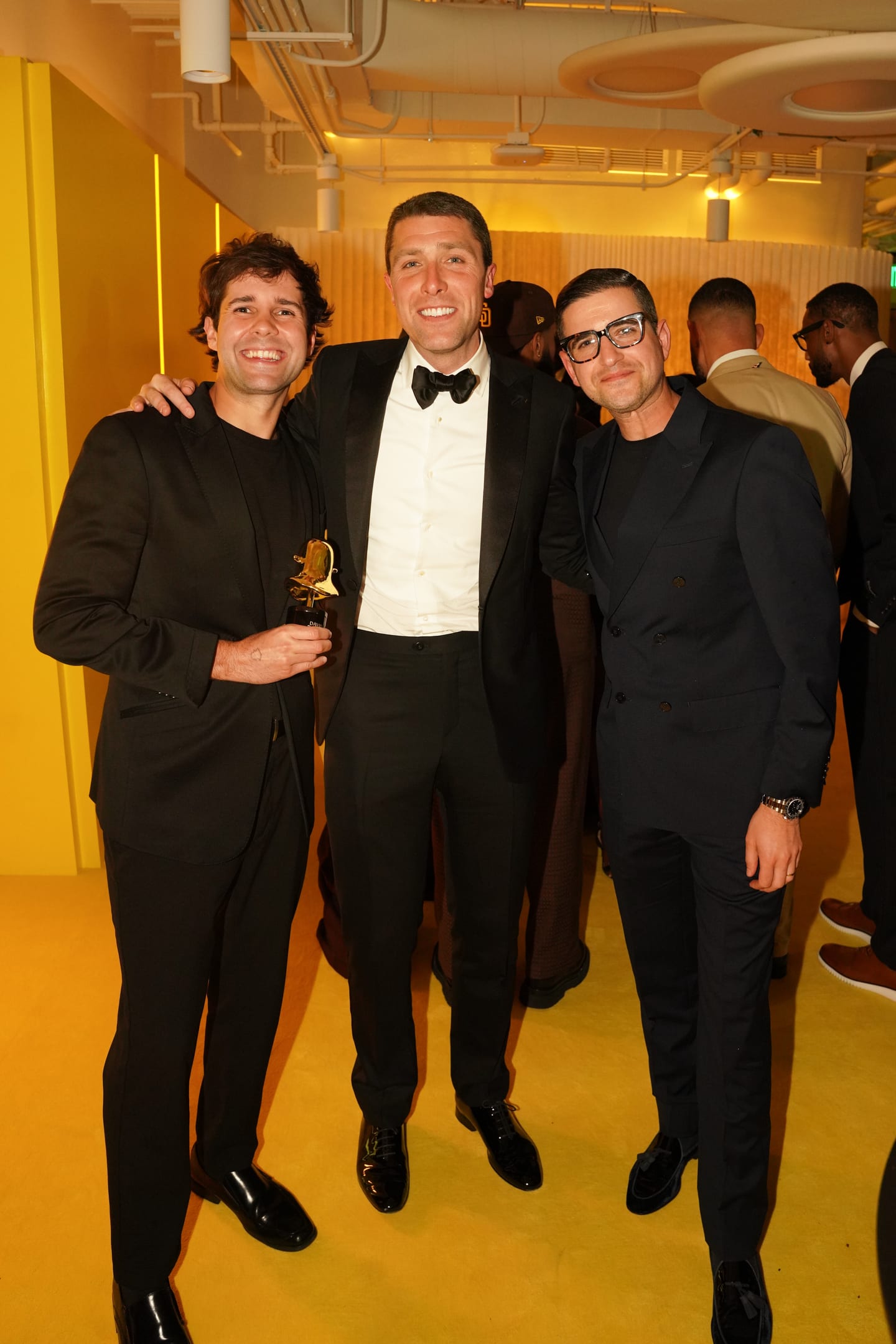 Creator of the Year David Dobrik holding his gold SNAPPYS trophy beside Jim Shepherd, Snap’s Senior Director of Global Content Partnerships, and a guest at The Snappys after-party in Santa Monica