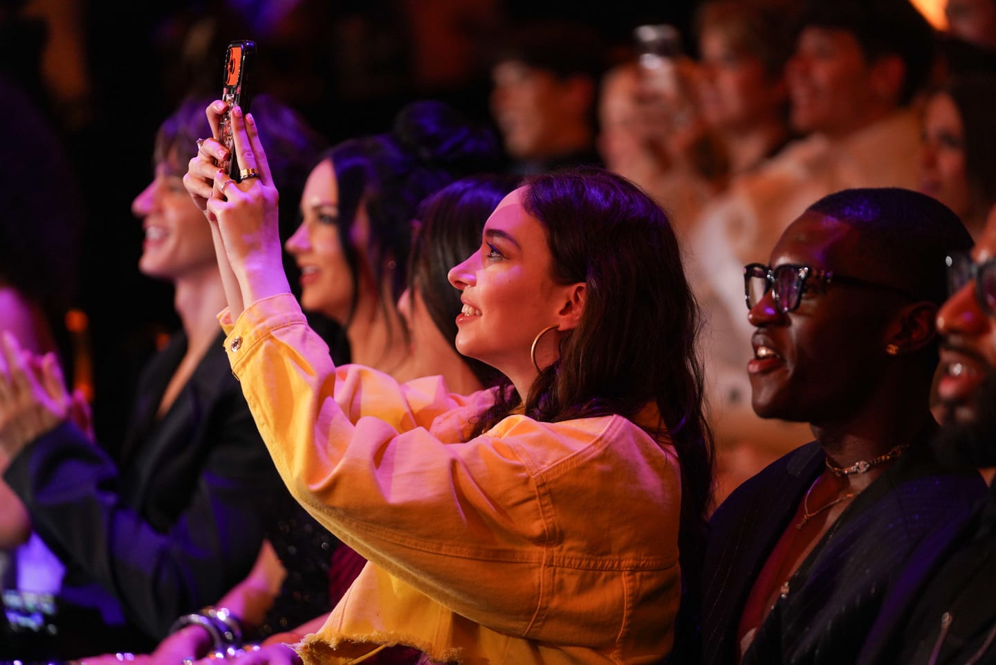 Audience member filming the stage at the SNAPPYS awards show in Santa Monica