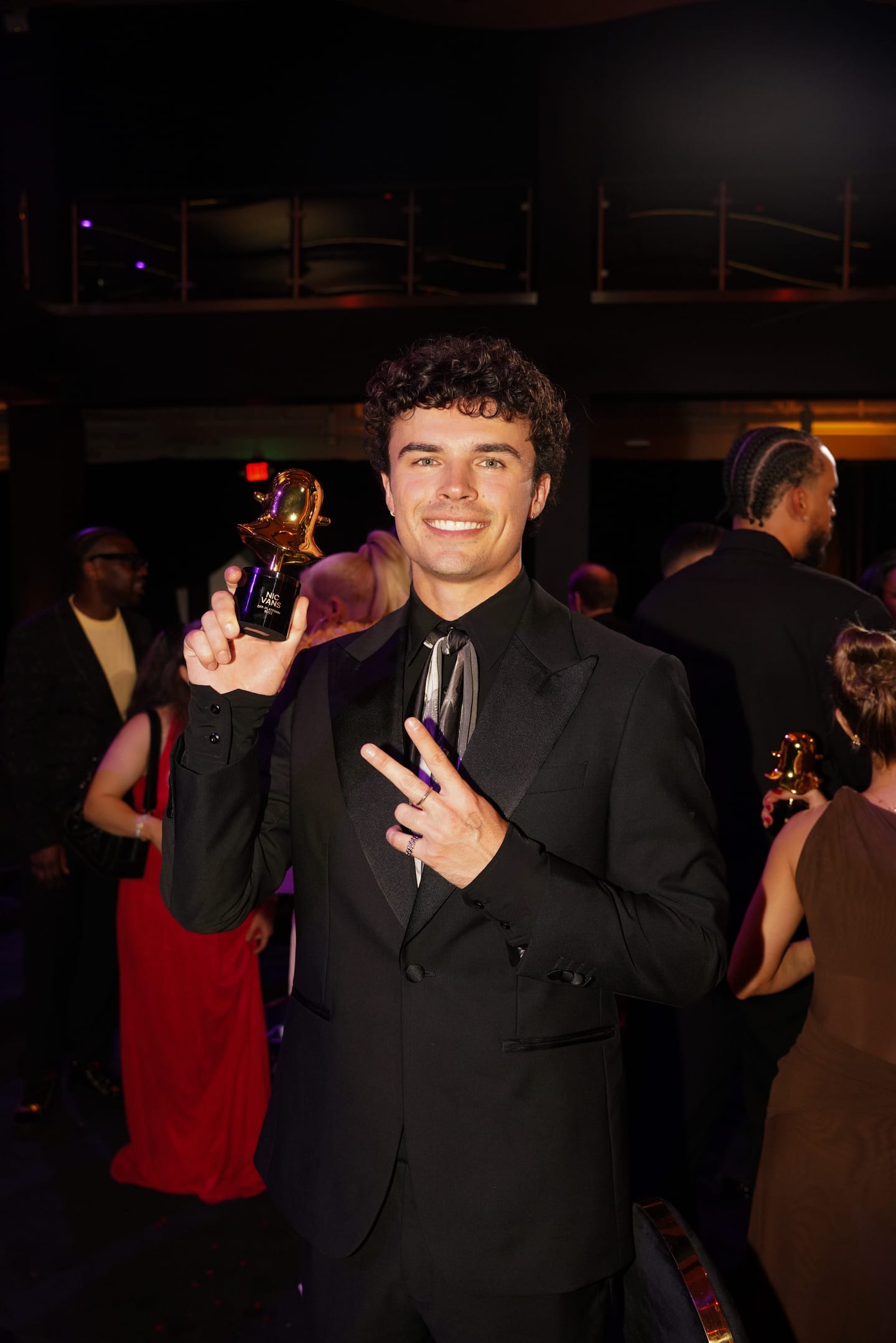 Snap creator Nic Vans holding his gold Snapchat ghost trophy after winning Off-Platform Buzz at The Snappys in Santa Monica
