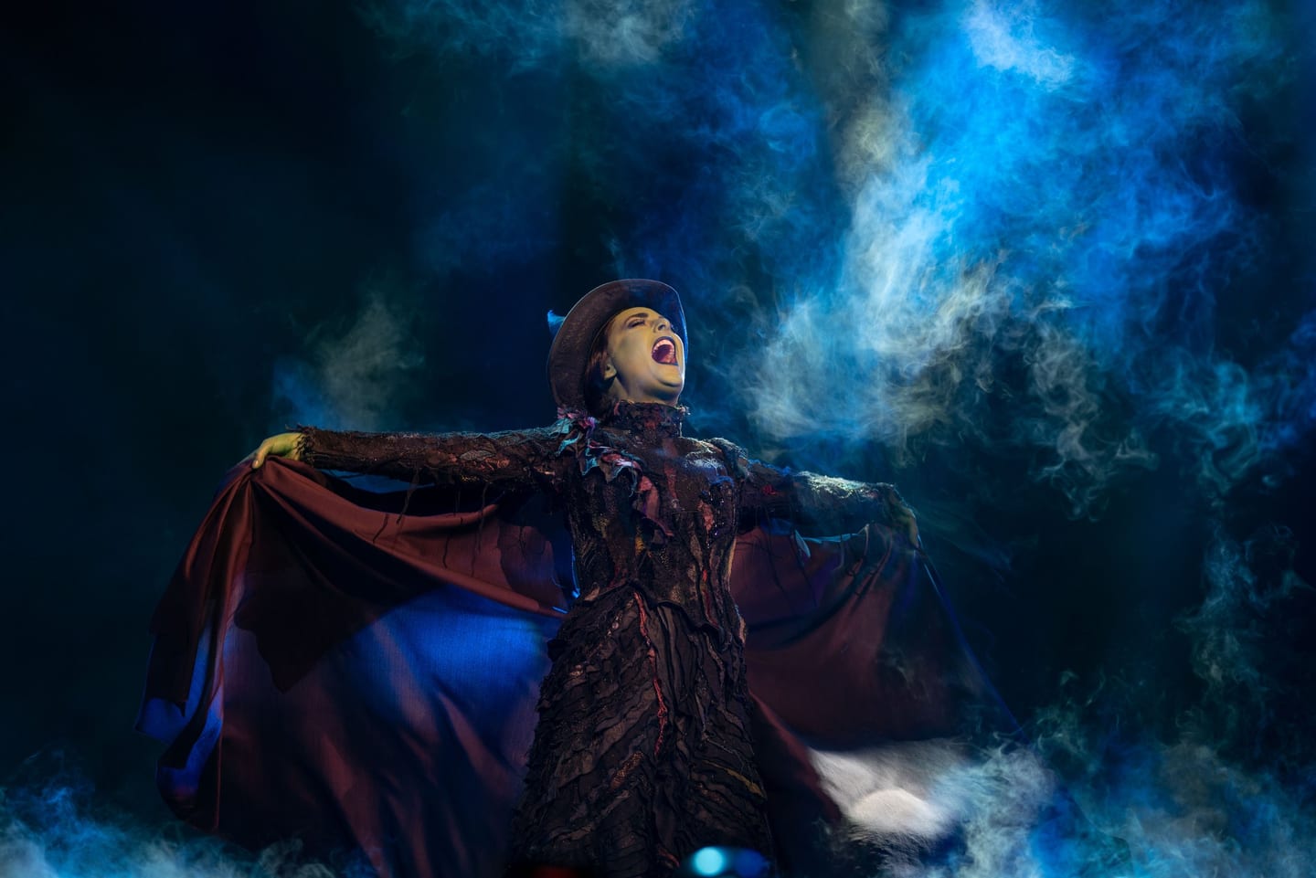Theatrical performer under blue light at an event