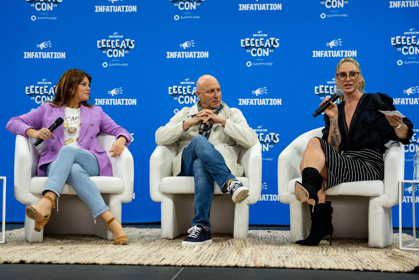 Chef Tom Colicchio seated on a panel in front of an EEEEEATSCON backdrop at the Infatuation food festival in Los Angeles