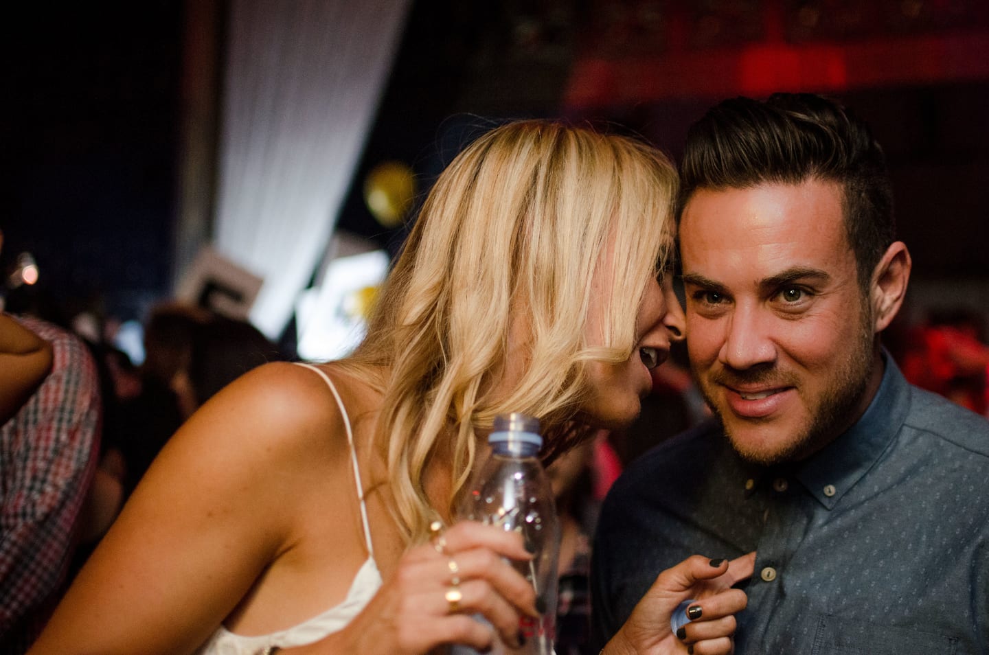 Two guests sharing a laugh at a party